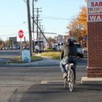 Man riding bike on street in Bailey's Crossroads